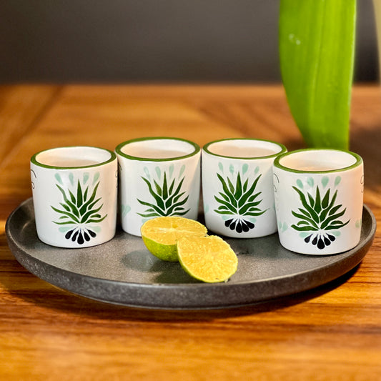 Handcrafted ceramic mezcal shot glasses with bold green agave talavera design