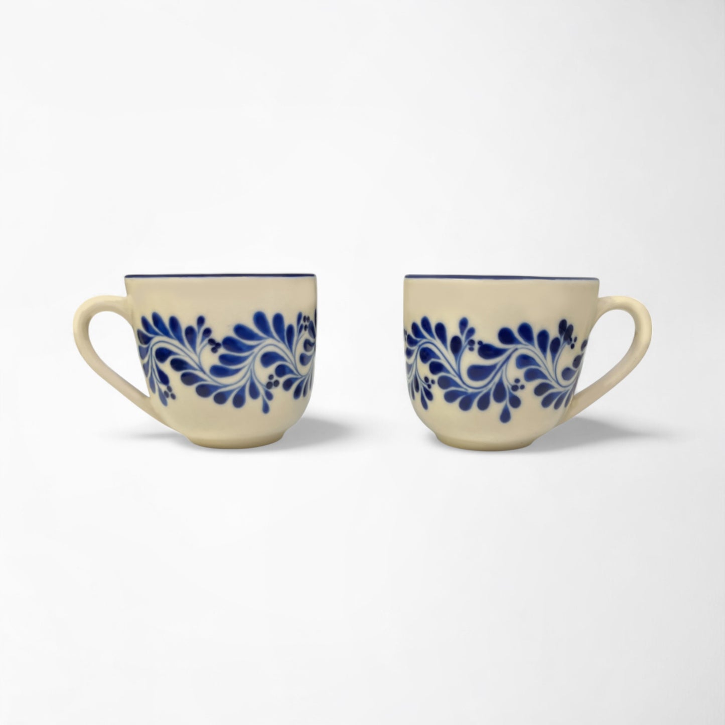 Pair of stylish ceramic mugs with vibrant blue designs, adding a pop of color to your kitchen décor.