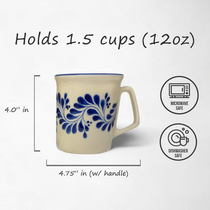 A handmade ceramic hot beverage mug with a blue floral pattern