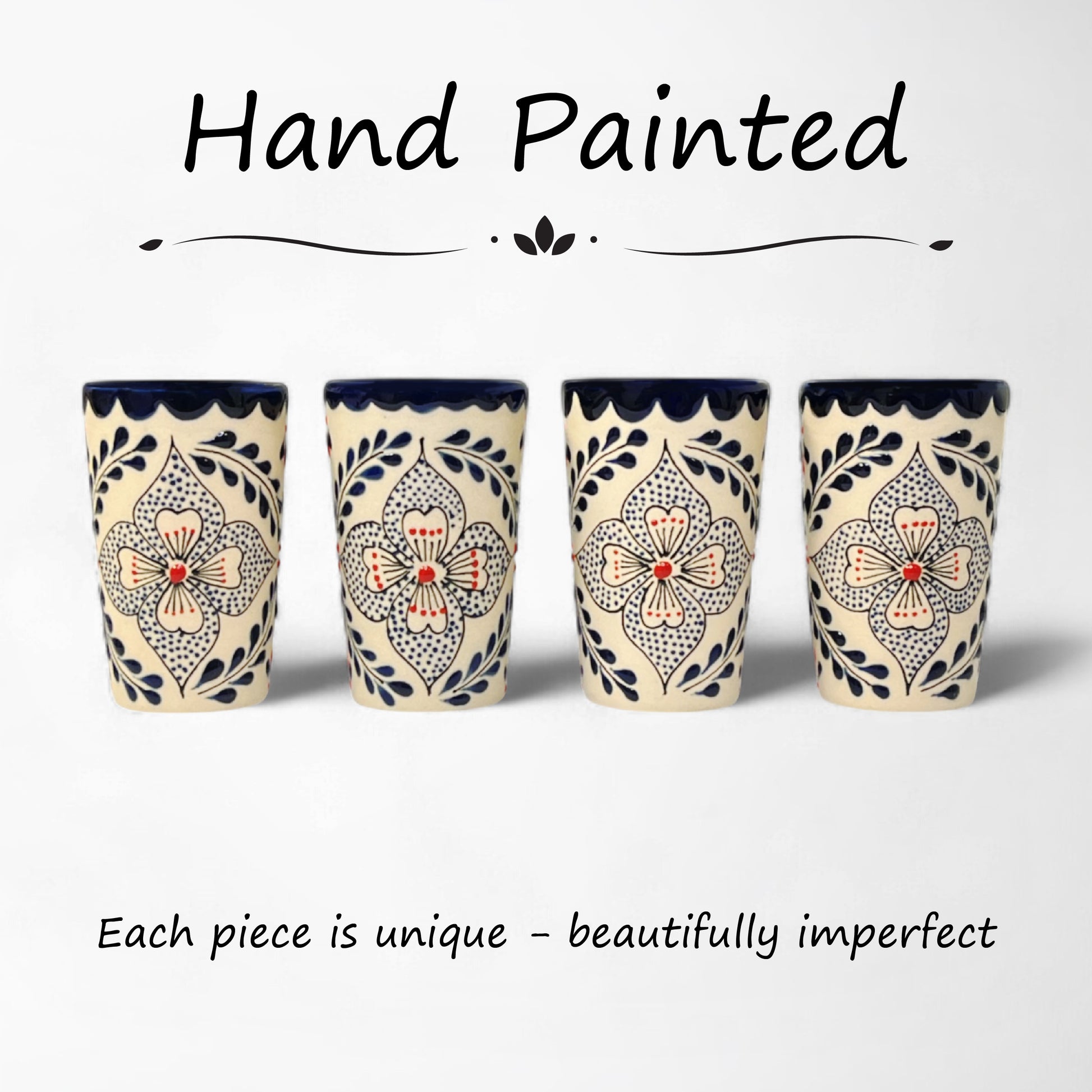 matching set of hand-painted ceramic shot glasses with intricate floral pattern