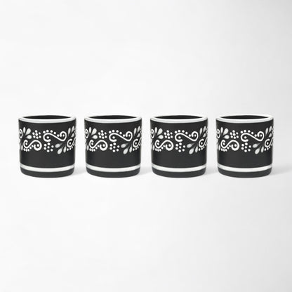 Handcrafted Mexican ceramic mezcal cup set with four black and white glasses shot glasses