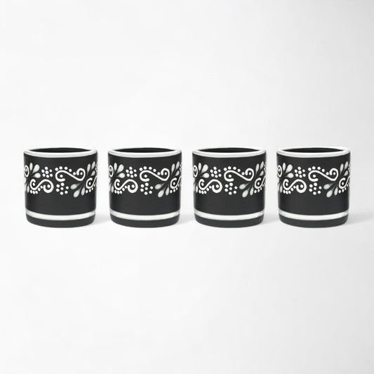 Handcrafted Mexican ceramic mezcal cup set with four black and white glasses shot glasses
