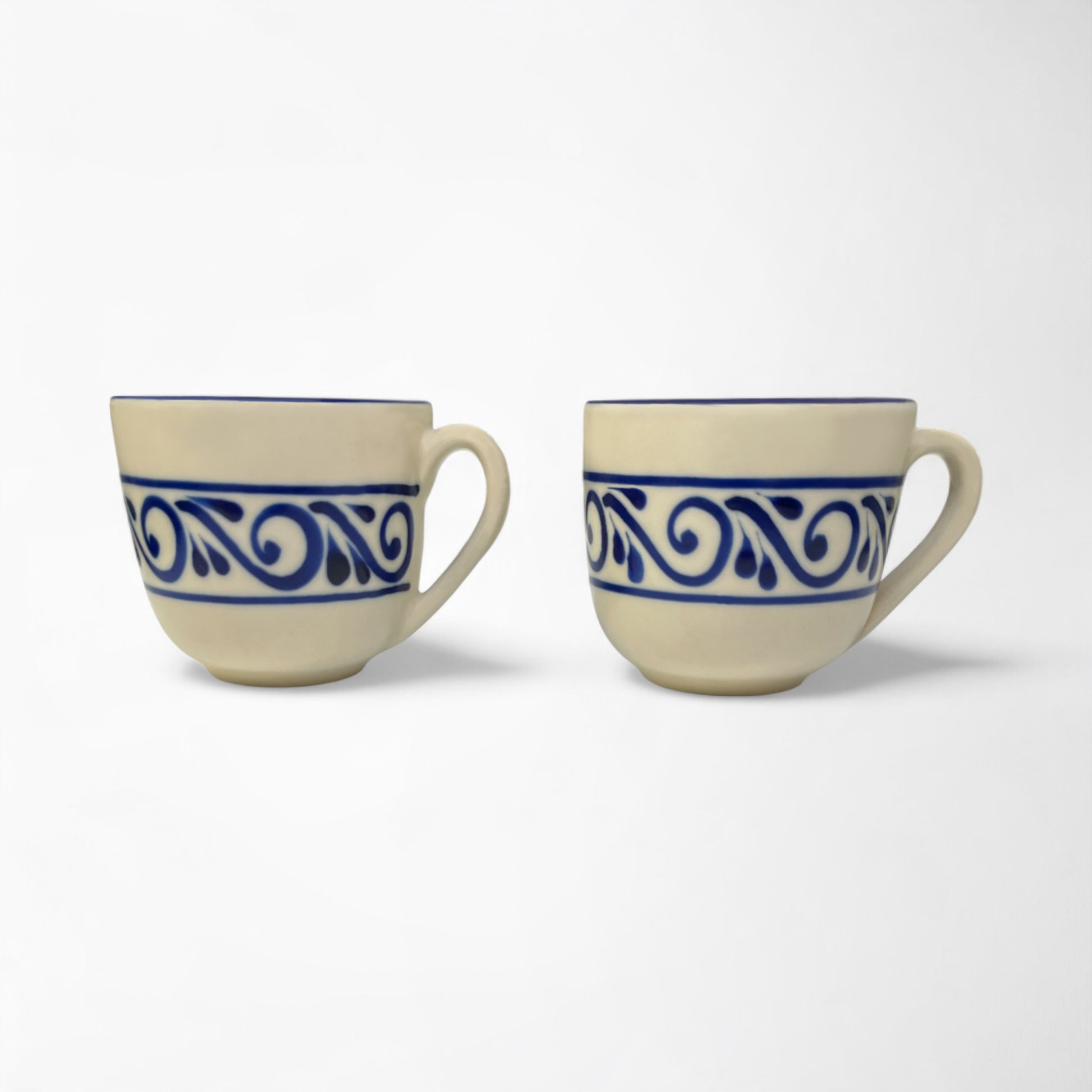 Pair of handcrafted mugs in matching designs, ideal for coffee lovers or home décor enthusiasts.