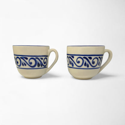 Pair of handcrafted mugs in matching designs, ideal for coffee lovers or home décor enthusiasts.