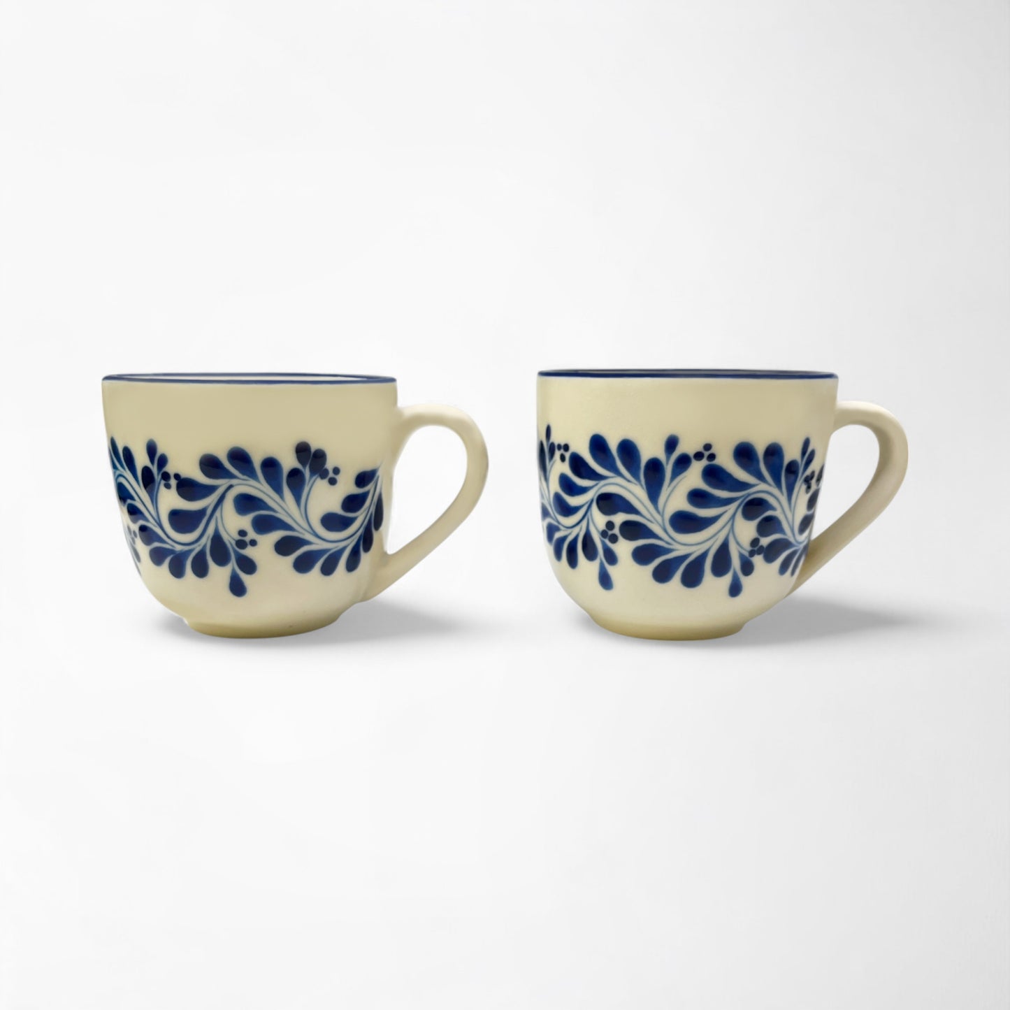 Set of two handcrafted ceramic mugs showcasing talavera designs, perfect for gifting or personal use.
