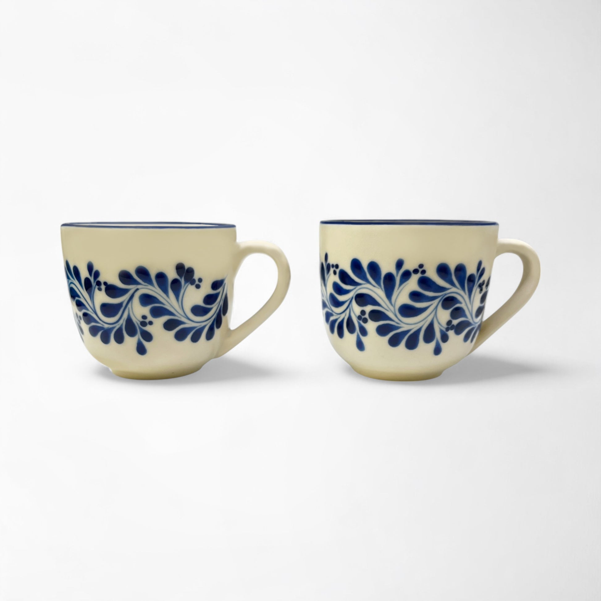 Set of two handcrafted ceramic mugs showcasing talavera designs, perfect for gifting or personal use.