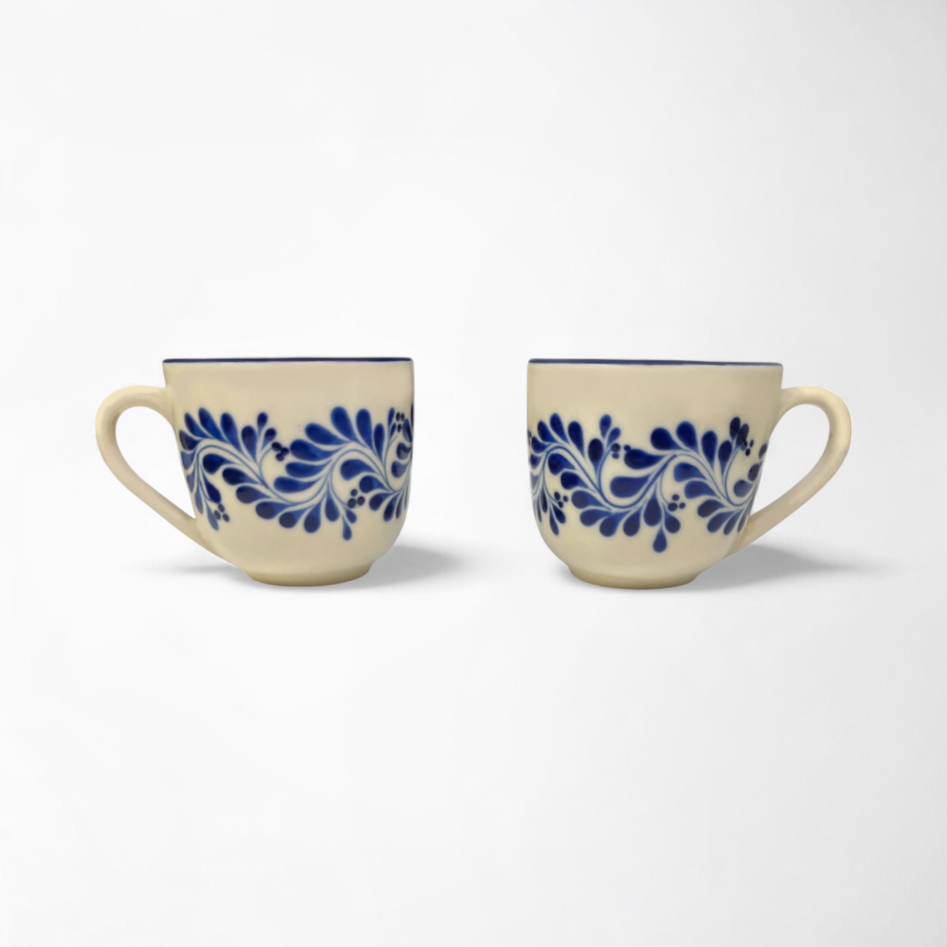Pair of stylish ceramic mugs with vibrant blue designs, adding a pop of color to your kitchen décor.