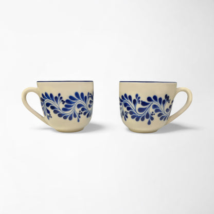 Pair of stylish ceramic mugs with vibrant blue designs, adding a pop of color to your kitchen décor.