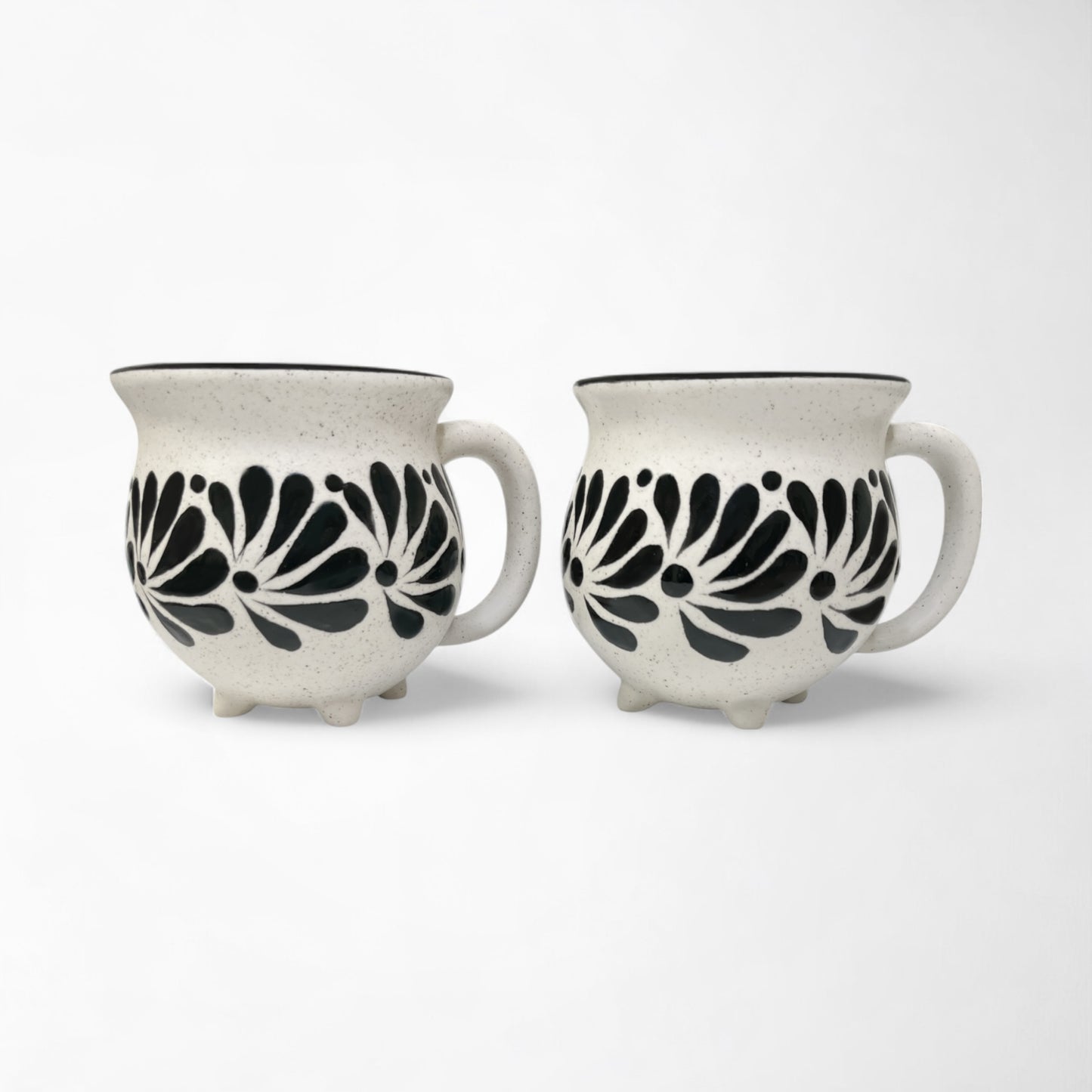 Pair of mugs with black and white patterns, adding decor to a kitchen or dining area.