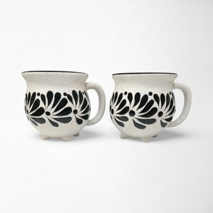 Pair of mugs with black and white patterns, adding decor to a kitchen or dining area.
