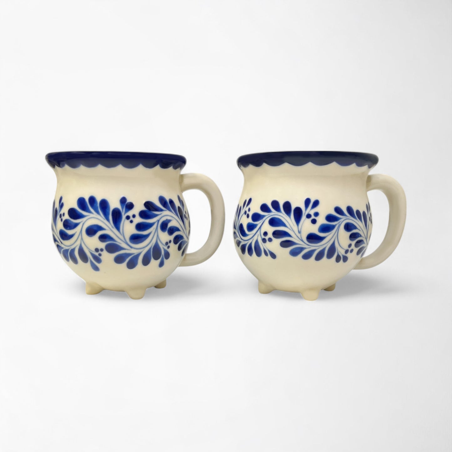 Two decorative mugs with a handmade touch, adding warmth and style to any beverage experience.