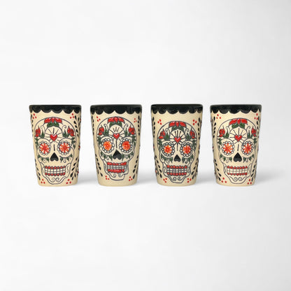 Set of four hand-painted ceramic shot glasses with colorful sugar skull design