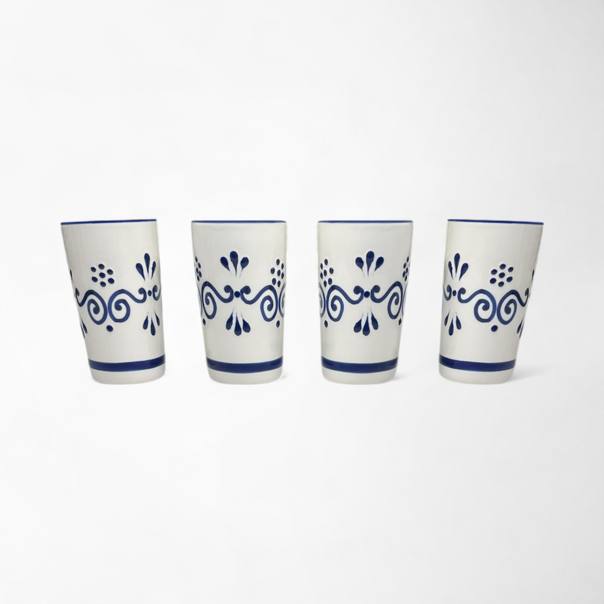 Four-piece hand-painted ceramic shot glass set, unique gift idea for friends and family. Made in Mexico